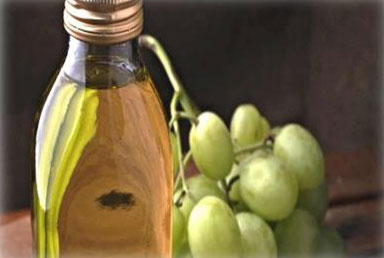 Wine bottle and grapes image representing our grapeseed oil